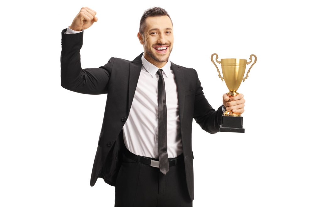 Procurement Manager holding a trophy